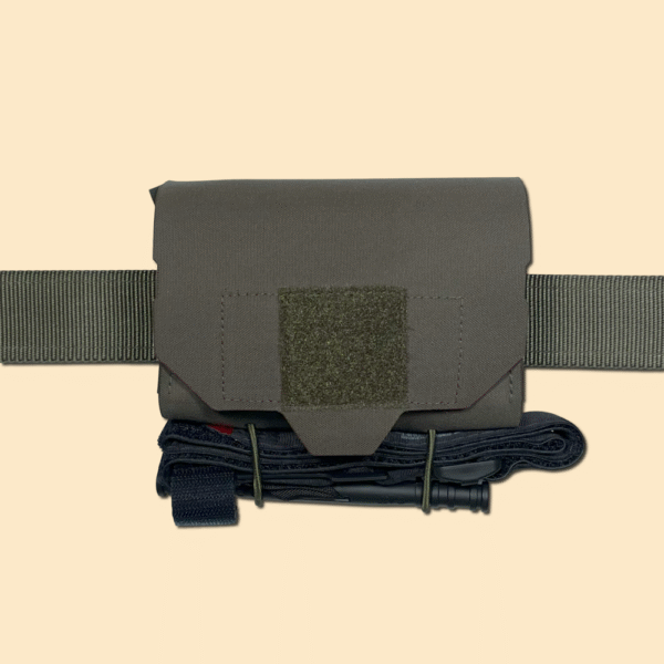 Quick Access Trauma Pouch with a TQ secured to bottom using TQ Retention Kit, mounted on a battle belt. Ranger Green