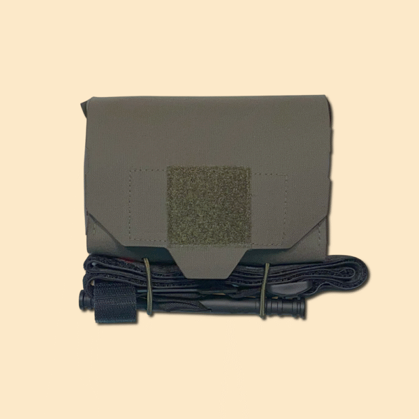 Quick Access Trauma pouch with tourniquet mounted on bottom using TQ Retention kit. Ranger Green.