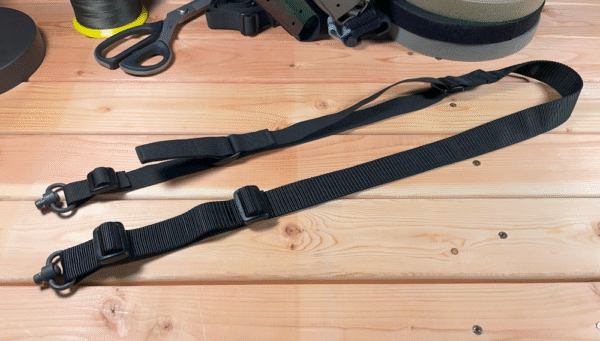 Our Slingus two-point gun sling with quick adjust and two Made in USA QD sling swivels displayed on a wooden table in our tactical equipment shop