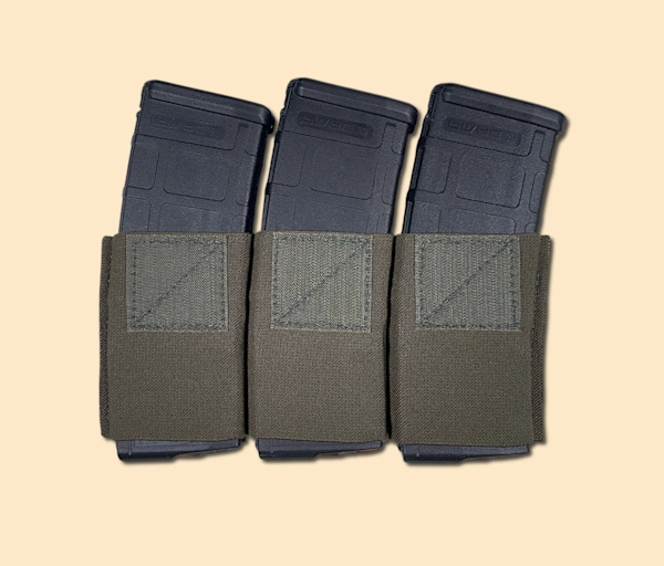 Elastic magazine insert with three 5.56 rifle magazines inserted