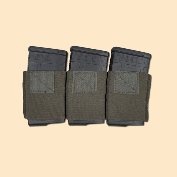 Elastic magazine insert with three 7.62 rifle magazines inserted